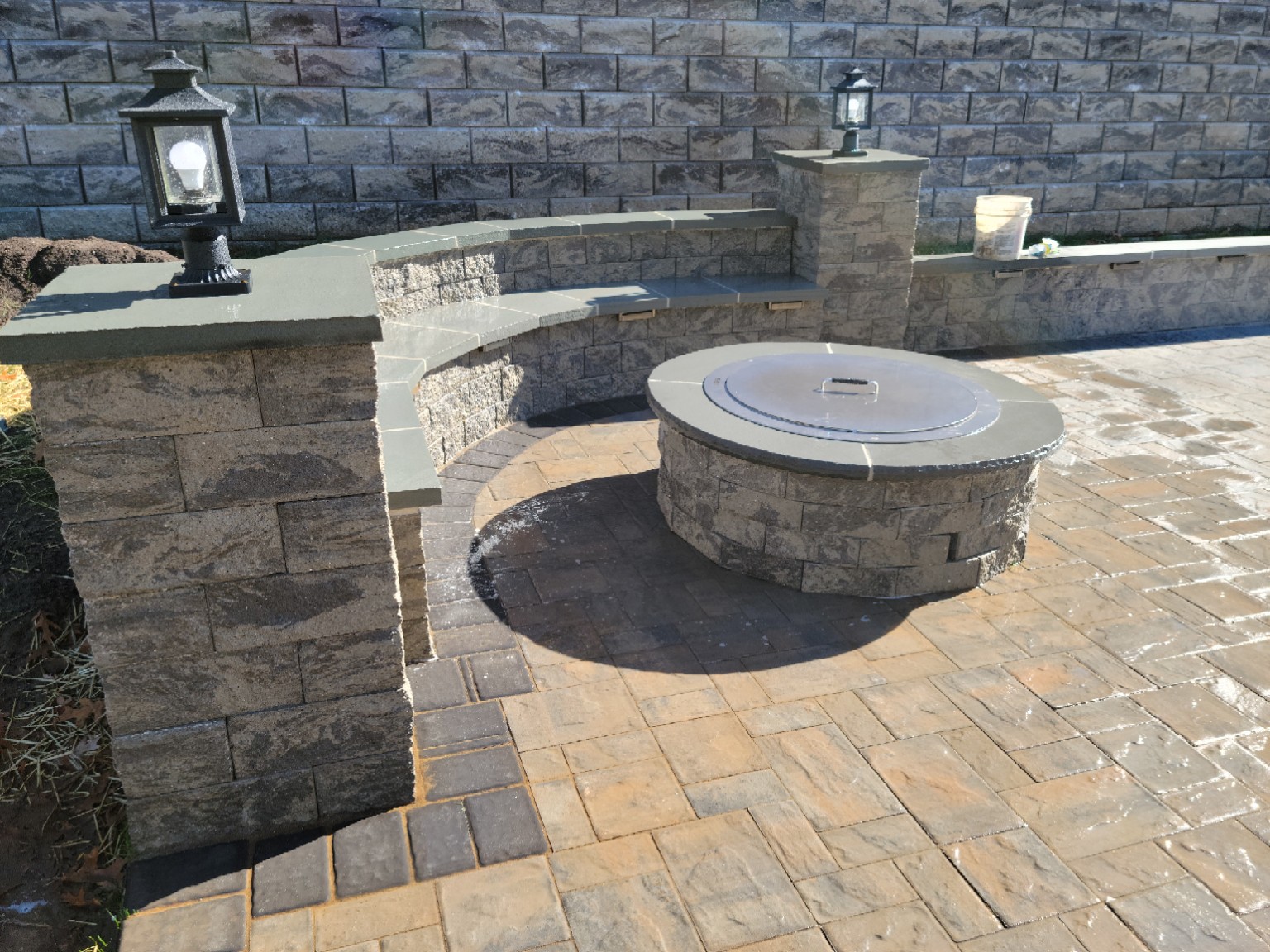 Stone fire pit and curved seating wall