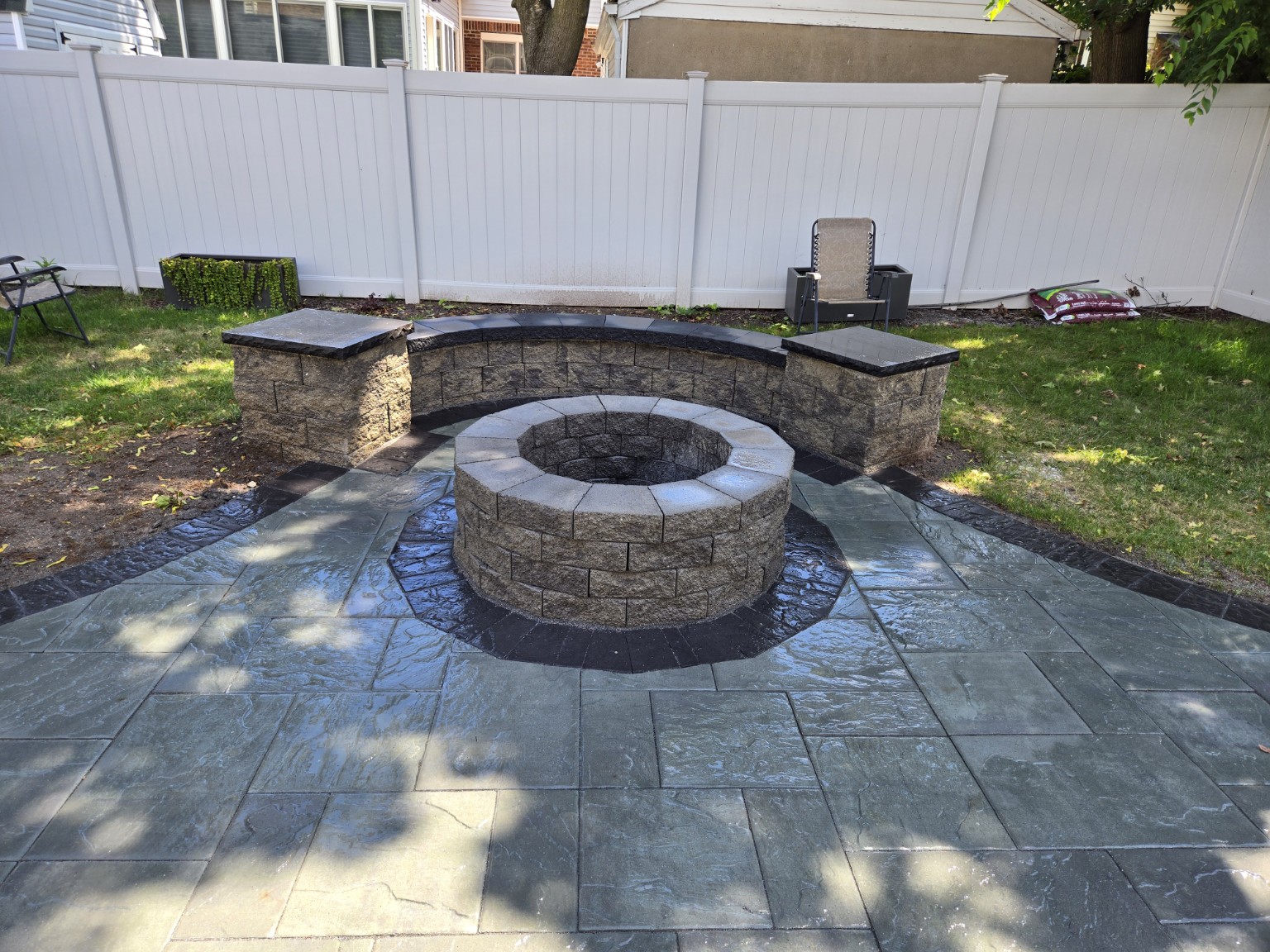 Circular stone fire pit and seating wall